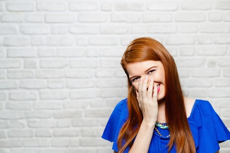 Facial Expressions Of Young Redhead Woman On Brick Wall