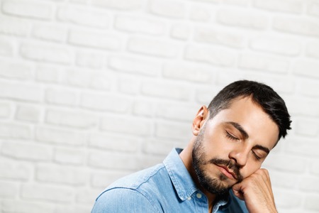 Facial Expressions Of Young Beard Man On Brick Wall
