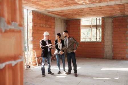 Realtor Showing New Home To Happy Married Coupleの写真素材