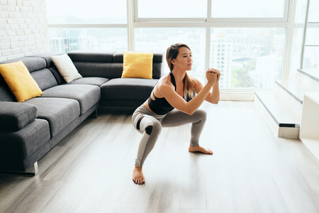 Adult Woman Training Legs Doing In and Out Squatの写真素材