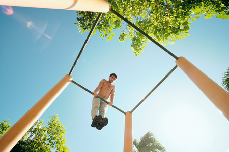 Adult Man Training Chest Muscles Doing Calisthenics Workout Outdoorsの写真素材
