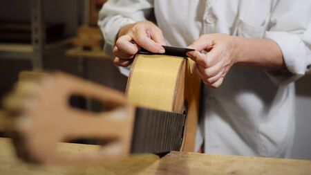 Woman Working As Lute Maker Polishing Classic Guitar