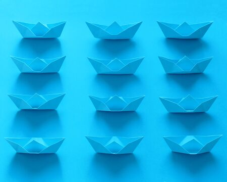 Close Up Real Origami Boats On Blue Backgroundの写真素材
