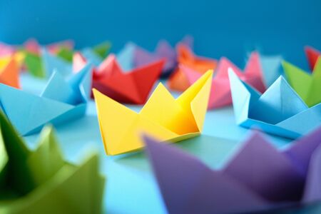 Fleet Of Authentic Origami Boats On Blue Backgroundの写真素材