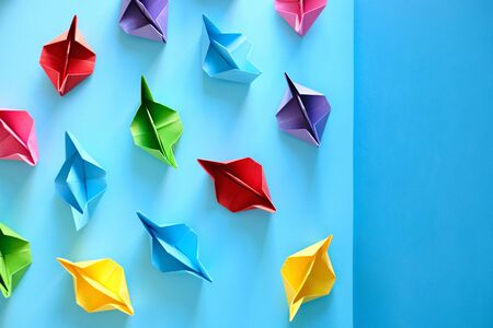 Fleet Of Authentic Origami Boats On Blue Background
