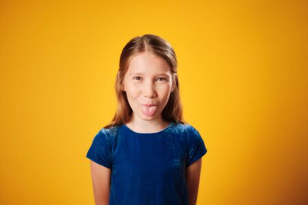 Young Redhead Preteen Girl Showing Tongue To Camera