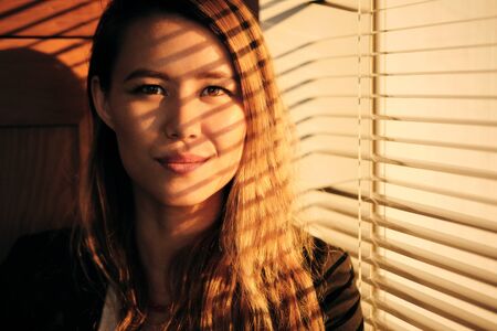 Business Woman Standing By Window With Venetian Blinds