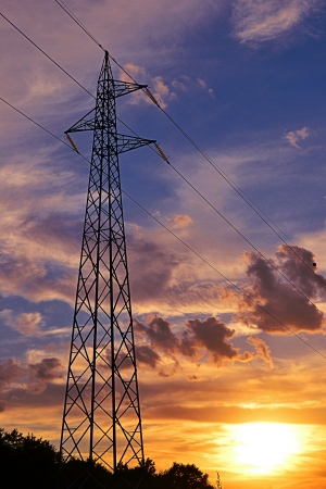 high voltage cables on cloudy sky at sunsetの写真素材