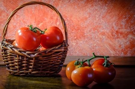 Cluster tomatoes on wooden table with natural lightingの写真素材