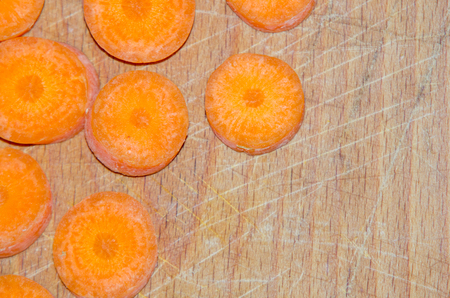 sliced ââcarrots on wooden chopping boardの写真素材