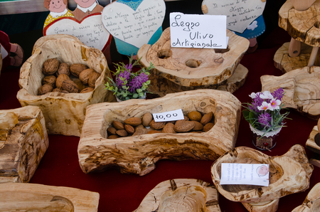 objects in olive wood on display in a stand of a craft marketの写真素材