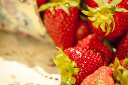 Fresh strawberries on a bucket and white tableclothの写真素材