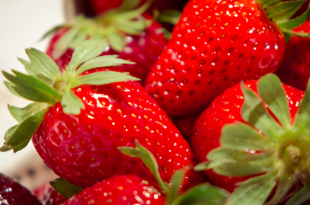 Fresh strawberries on a bucket and white tableclothの写真素材