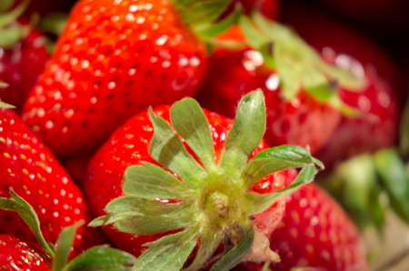 fresh strawberries on a bucket and white tableclothの写真素材