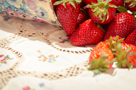 Fresh strawberries on a bucket and white tableclothの写真素材
