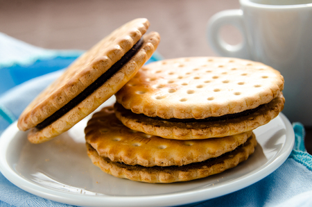 Italian breakfast with a cup of coffee and chocolate-filled biscuitsの写真素材