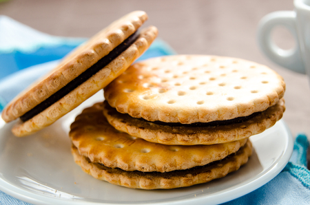 Italian breakfast with a cup of coffee and chocolate-filled biscuitsの写真素材