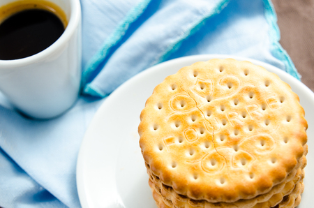 Italian breakfast with a cup of coffee and chocolate-filled biscuitsの写真素材