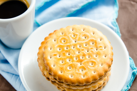 Italian breakfast with a cup of coffee and chocolate-filled biscuitsの写真素材