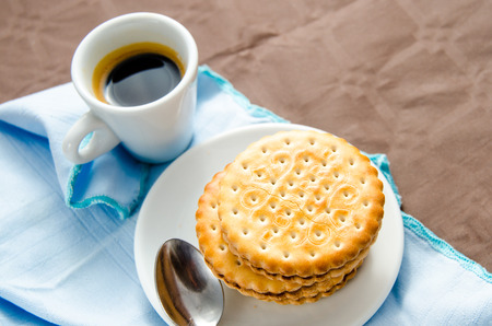 Italian breakfast with a cup of coffee and chocolate-filled biscuitsのeditorial素材