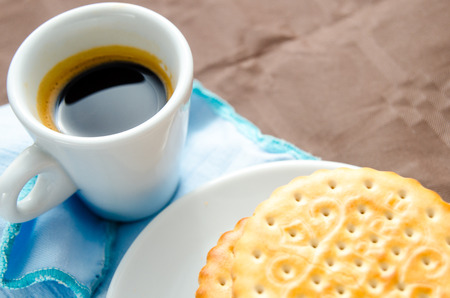 Italian breakfast with a cup of coffee and chocolate-filled biscuitsの写真素材