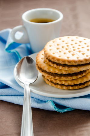 Italian breakfast with a cup of coffee and chocolate-filled biscuitsの写真素材