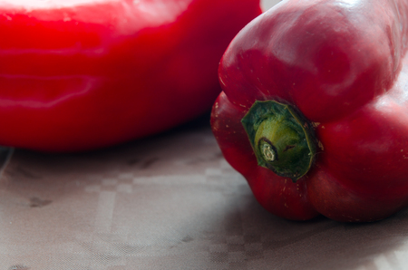 composition of red peppers on brown background and blue napkinの写真素材