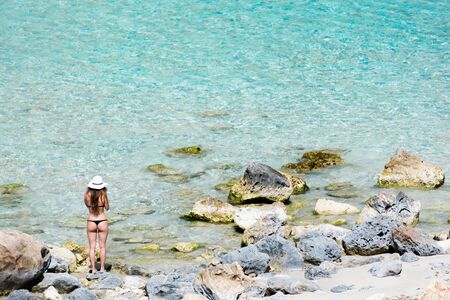 Woman on a lonely beach with blue sky, Cala Marmols, Majorcaの写真素材