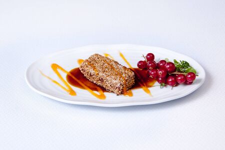 A cheese breaded with sesame on a white backgroundの写真素材