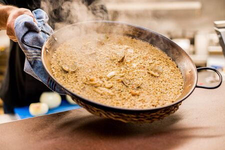 Presentation of hot and ready-to-eat paellaの写真素材