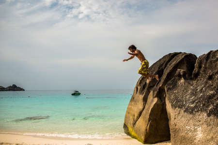 Falling off a Stone at Tropical Island. Thailand Jumping.の写真素材