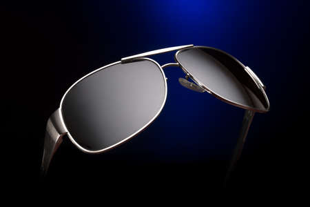 Feashion Sunglasses, stylish with a blue and black background.の写真素材