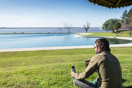Enjoying Mate drink looking at the river. Buenos Aires. Argentina.の写真素材