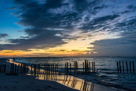 Sunset with people swimming at Caribbean Island. Mexico, Cancun.の写真素材