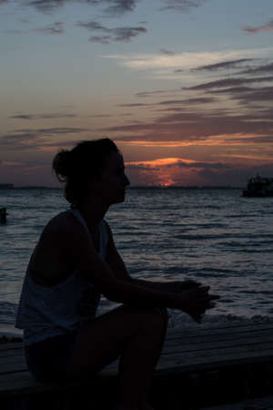 Sunset with people swimming at Caribbean Island. Mexico, Cancun.の写真素材