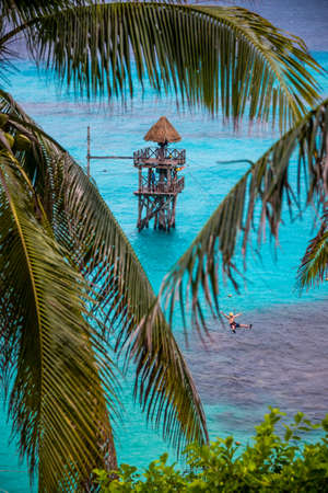 Going down a zip wire over the caribbean Sea. At Isla Mujeres Mexico.の写真素材