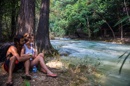 Cute couple looking at the river, hiking at Chiapas.の写真素材
