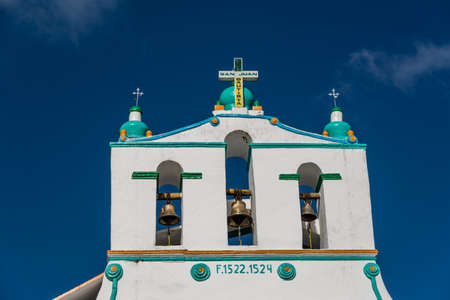 Traditional church wooden door and green sculpture.