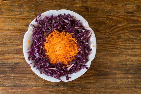 Cuisine salad,  bowl and wooden table. Cooking a salad.の写真素材