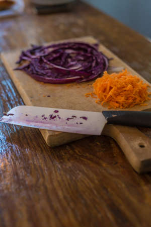 Cuisine elements,  ceramic knife and wooden table. Cooking a salad.の写真素材