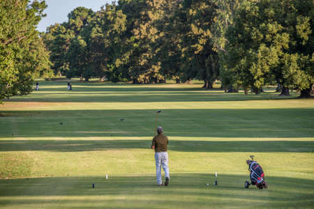 Golfer Swing and Tee Off at a beautiful golf course on Argentina, Buenos Aires. Healthy sport.のeditorial素材