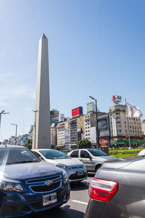 Buenos Aires, Argentina - April 9, 2015: Unidentified business people walking down the street at iconic building  Obelisco on April 9, 2015 in Buenos Aires, Argentinaのeditorial素材