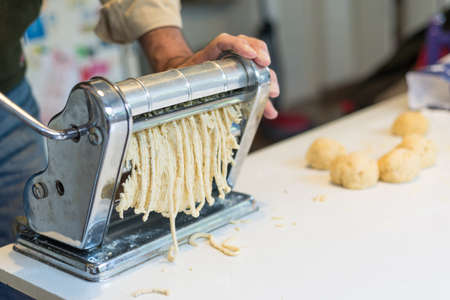 Cooking Home Made Spaghetti with traditional italian recepie and pasta machine.の写真素材
