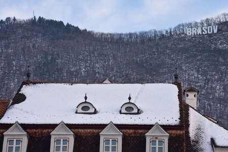 Brasov, Romania. February 4, 2017. Snowy Roof. Old Building at the Council Square (Piata Sfatului)