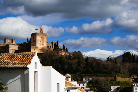 Landscape with torre de la vela of alhambra palace and sierra nevada mountain rangeのeditorial素材
