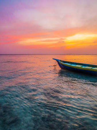 Fisherman's boat at sunset in the atoll of Ukulhas, Maldivesの写真素材