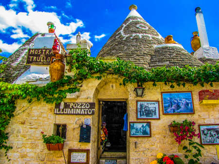 ALBEROBELLO, ITALY - JULY 27, 2011: Picturesque street in the old town with the traditional Apulian dry stone huts with a conical roof, known as "trulli".のeditorial素材