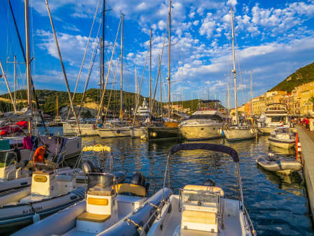 BONIFACIO, FRANCE - AUGUST 5, 2014: Boats and yachts on the port at sunset.