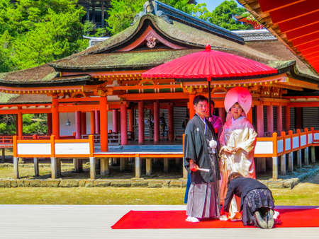 MIYAJIMA, JAPAN - MAY 26, 2015: Unidentified Japanese couple in traditional dresses on their wedding day in Itsukushima Shinto Shrine.のeditorial素材