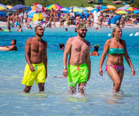 CALA BRANDINCHI, ITALY - JULY 25, 2016:  People on the beach of Cala Brandinchi in the province of Olbia, Sardinia, Italy.のeditorial素材